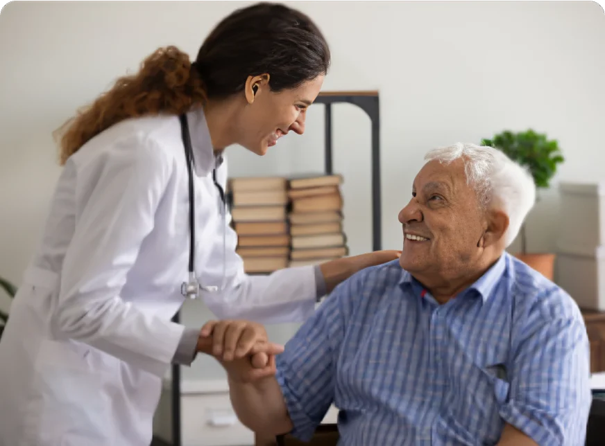 A Schoolcraft Memorial Hospital provider helping senior patient in the Family Medicine department